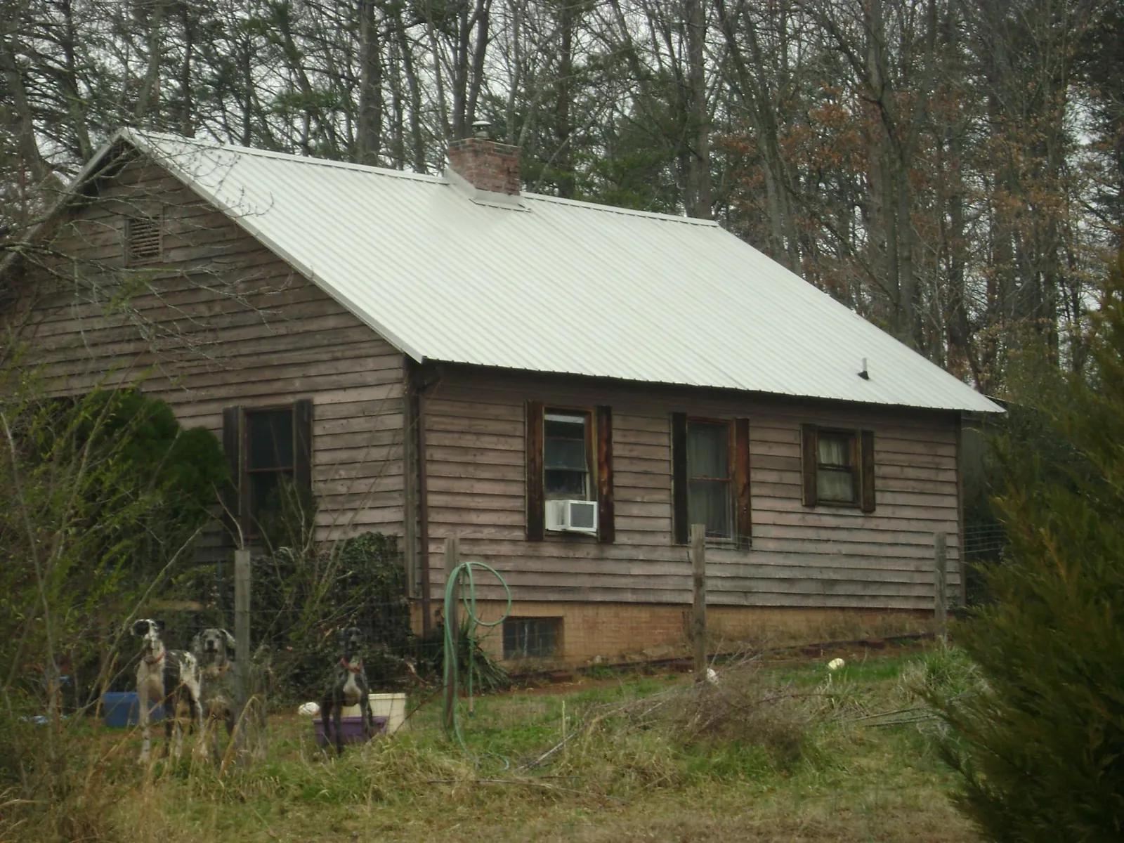 White metal roof on an old wood sided farmhouse, from a Metal Roof Installation job in Saltsburg